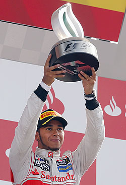McLaren Formula One driver Lewis Hamilton of Britain holds up the trophy on the podium after winning the Italian F1 Grand Prix at the Monza circuit on Sunday