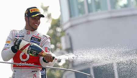 McLaren Formula One driver Lewis Hamilton of Britain sprays champagne on the podium after winning the Italian F1 Grand Prix at the Monza circuit on Sunday