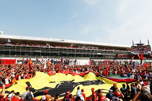 Ferrari fans unfurl a giant Prancing Horse flag on the track