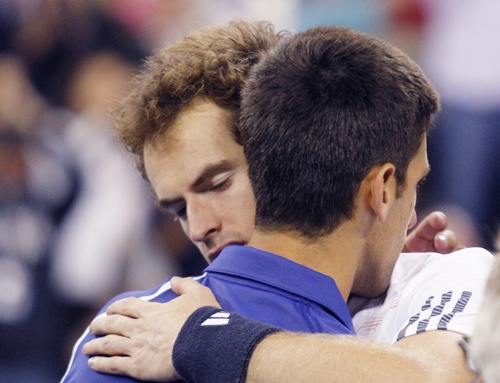 Britain's Andy Murray embraces Serbia's Novak Djokovic