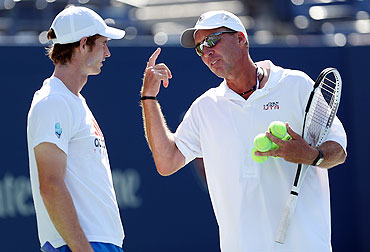 Andy Murray talks with his coach, Ivan Lendl, during a practice session
