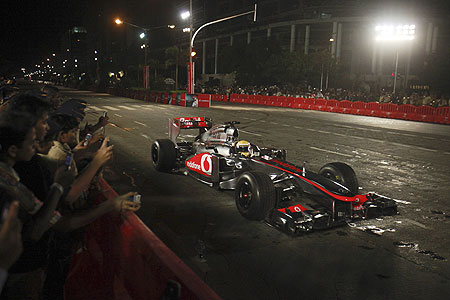 McLaren Formula One driver Lewis Hamilton drives his F1 car on the BKC stretch in Mumbai on Sunday