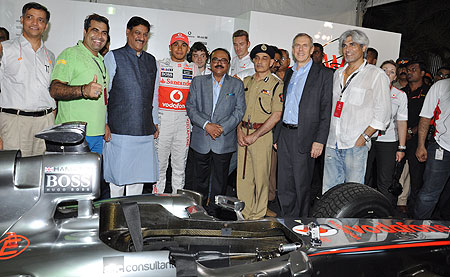 McLaren's Lewis Hamilton (centre) is flanked by Chief Minister of Maharashtra Prithiviraj Chavan, PWD Minister Chaggan Bhujbal, Satyapal Singh, Commissioner of Mumbai Police and Marten Pieters, CEO, Vodafone India (2nd from right) at a promotional event in Mumbai on Sunday