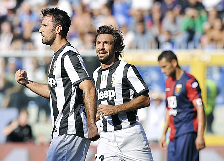 Juventus' Mirko Vucinic (left) celebrates with teammate Andrea Pirlo after scoring against Genoa on Sunday