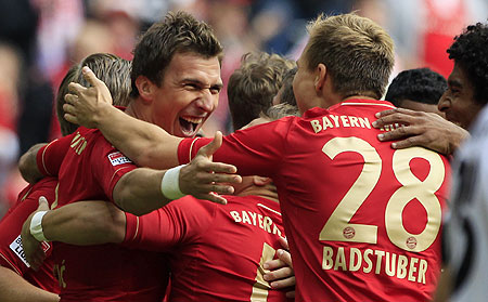 Bayern Munich's Mario Mandzukic (left) celebrates with teammates after scoring against FSV Mainz 05 during their Bundesliga match in Munich on Saturday