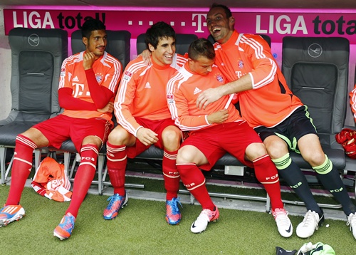 FC Bayern Munich's new midfielder Javi Martinez (second left) sits on the substitute bench