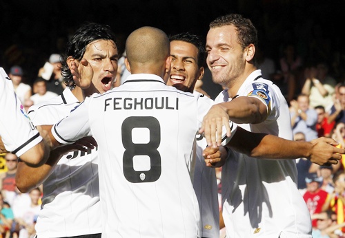 Valencia's Sofiane Feghouli celebrates with teammates