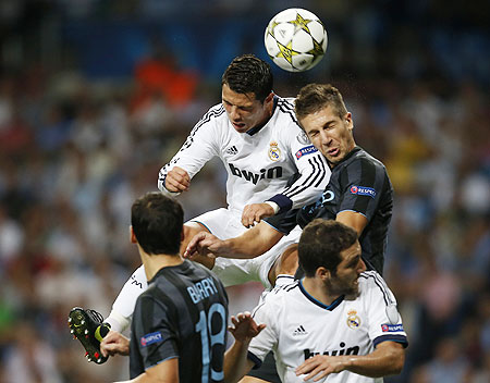 Real Madrid's Cristiano Ronaldo (top left) goes for a header as he is challenged by Manchester City's Matija Nastasic