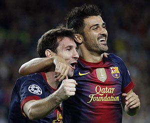 Barcelona's Lionel Messi (left) is congratulated by teammate David Villa after scoring his second goal against Spartak Moscow on Wednesday