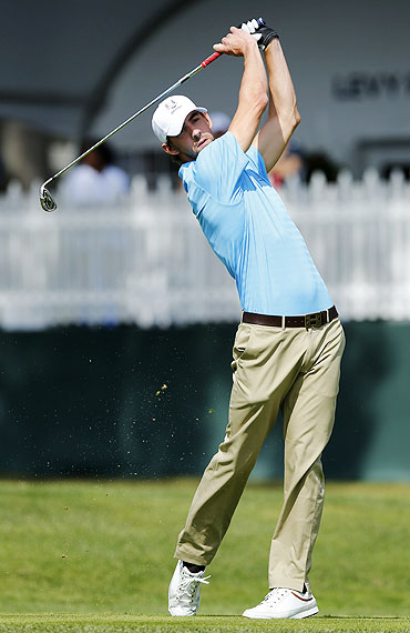 US Olympian Michael Phelps hits his tee shot on the second hole during the Captains and Celebrity Scramble at the 39th Ryder Cup golf matches at the Medinah Country Club in Medinah, Illinois