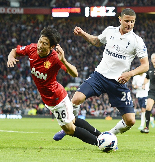 Manchester United's Shinji Kagawa (left) is challenged by Tottenham Hotspur's Kyle   Walker