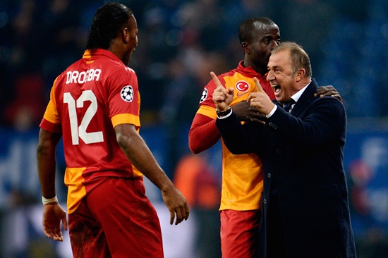 Head coach Fatih Terim of Galatasaray celebrates with Didier Drogba and Dany Nounkeu