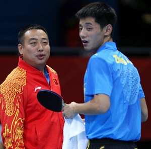 Zhang Jike (right) of China talks with coach Liu Guoliang