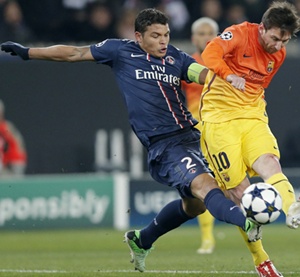 Paris St Germain's Alex (left) challenges Barcelona's Lionnel Messi