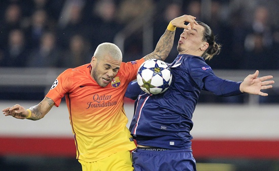 Paris St Germain's Zlatan Ibrahimovic (right) challenges Barcelona's Daniel Alves