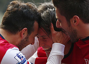 Arsenal's Tomas Rosicky (centre) celebrates his second goal with Santi Cazorla (left) during their English Premier League match against West Bromwich on Saturday