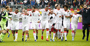 Bayern Munich's players celebrate after winning their German Bundesliga match against Eintracht Frankfurt and the German League title in Frankfurt on Sunday