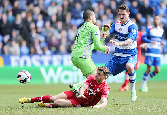 Jay Rodriguez of Southampton scores the opening goal past 'keeper Adam Federici of Reading during their EPL match at the Madejski Stadium on Saturday