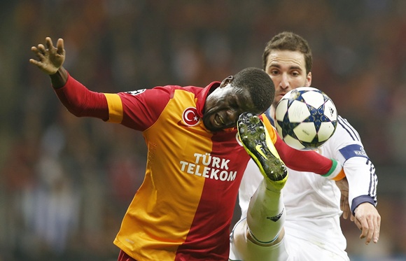 Galatasaray's Emmanuel Eboue (left) is challenged by Real Madrid's Raphael Varane