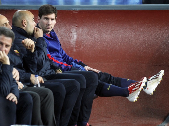 Barcelona's Lionel Messi sits on the bench