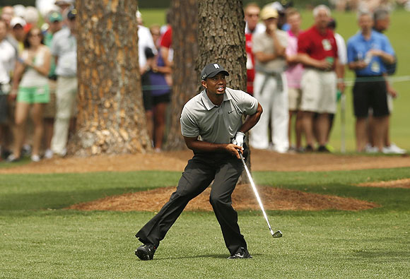 Tiger Woods of the U.S. watches his approach shot to the seventh green during first round play in the 2013 Masters golf tournament at the Augusta National Golf Club in Augusta, Georgia on Thursday