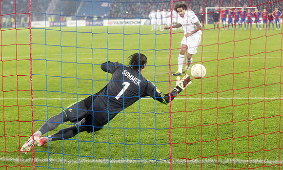 FC Basel's goalkeeper Yann Sommer makes a valiant save to deny Tottenham Hotspur's Tom Huddlestone (right) from scoring of a penalty during their Europa League quarter-final second leg match in Basel on Thursday