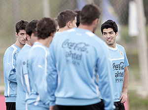 Luis Suarez (right) of Uruguay's chats with teammates during a training session