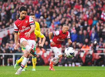 Mikel Arteta of Arsenal scores a goal off a free-kick during their match against Norwich City at Emirates Stadium on Saturday