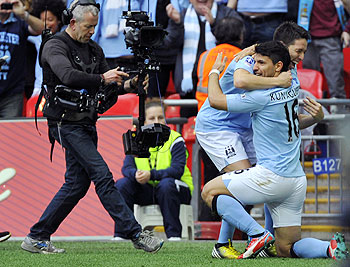 Manchester City's Sergio Aguero (right) celebrates scoring against Chelsea with teammate Samir Nasri during their FA Cup semi-final soccer match at Wembley Stadium in London on Sunday