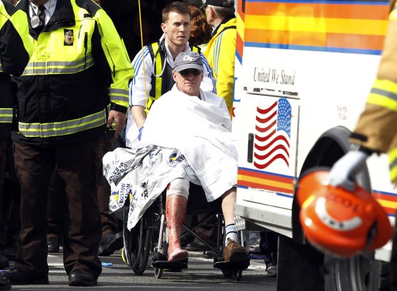 An injured runner seen after explosions went off at the 117th Boston Marathon on Monday, April 15