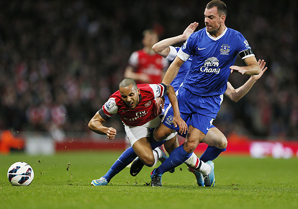 Arsenal's Theo Walcott (left) is fouled by Everton's Darron Gibson during their English Premier League match on Tuesday