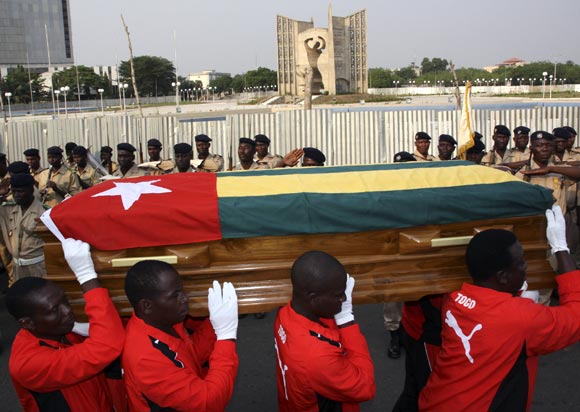 Pallbearers carry the coffin of Togo soccer team's assistant coach Amalete Abalo during the funeral service in front of Congress Palace in Lome, on January 15, 2010.