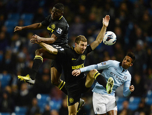Wigan Athletic's Maynor Figueroa (left) and James McCarthy (2nd from left) challenge Manchester City's Scott Sinclair during their English Premier League match on Wednesday