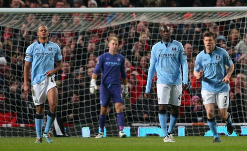 Manchester City players react after losing a match