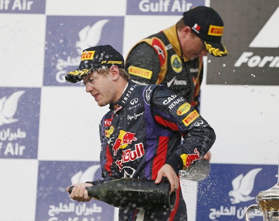 Sebastian Vettel of Germany and Lotus driver Kimi Raikkonen