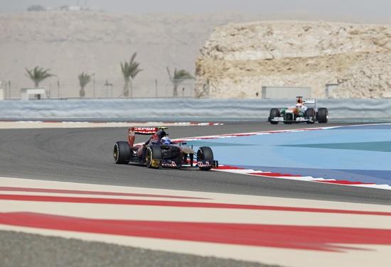 Toro Rosso Formula One driver Daniel Ricciardo of Australia (front) drives in front of Force India driver Paul di Resta