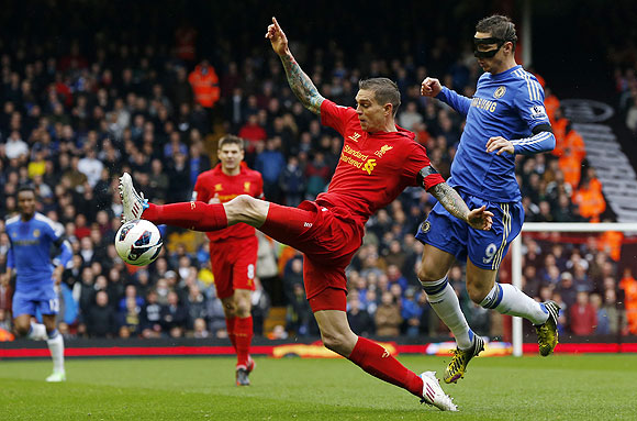 Chelsea's Fernando Torres (right) challenges Liverpool's Daniel Agger during their English Premier League match at Anfield on Sunday