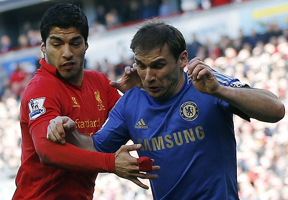 Chelsea's Branislav Ivanovic (right) challenges Liverpool's Luis Suarez during their English Premier League soccer match at Anfield in Liverpool on Sunday