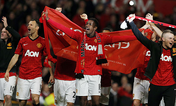 Manchester United's Ryan Giggs (left), Danny Welbeck (centre) and Tom Cleverley celebrate after clinching the English Premier League title Old Trafford on Monday