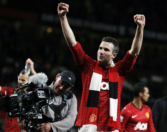 Manchester United's Robin van Persie celebrates after his team clinched the English Premier League title on Monday