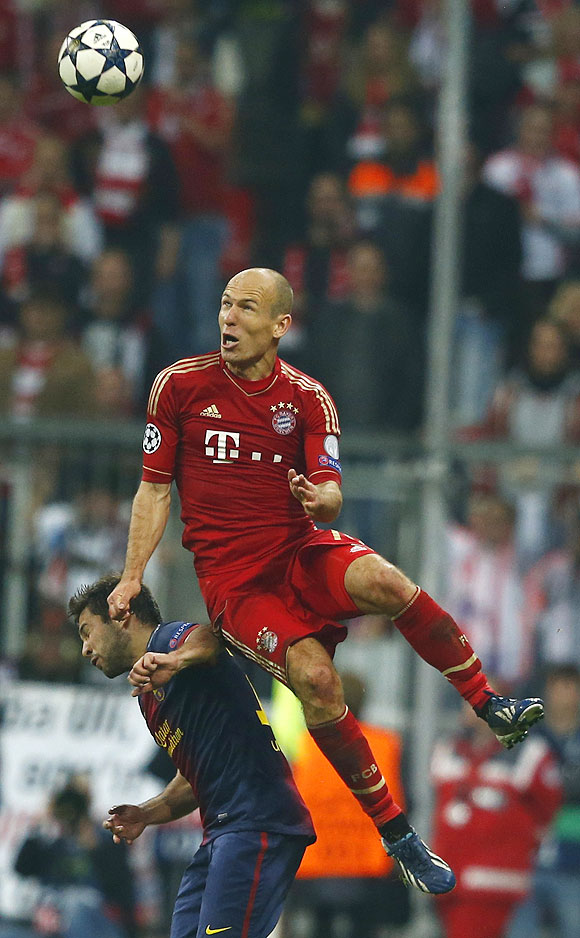 Bayern Munich's Arjen Robben (top) jumps for the ball over Barcelona's Jordi Alba during their Champions League semi-final first leg match on Tuesday