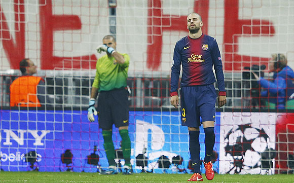 Barcelona's Gerard Pique (right) and goalkeeper Victor Valdes react after Bayern Munich's Mario Gomez scored on Tuesday