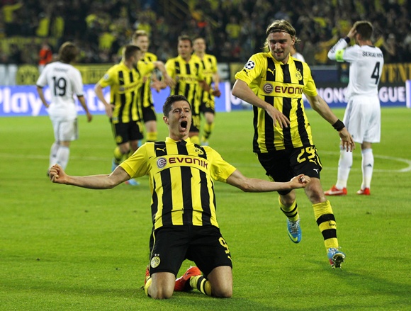 Borussia Dortmund's Robert Lewandowski celebrates with his teammate Marcel Schmelzer (right)