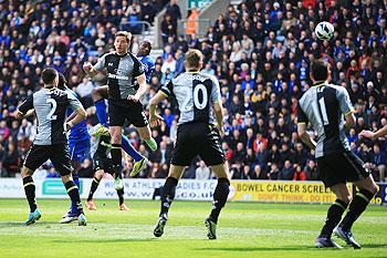 Emmerson Boyce (3rd left) of Wigan Athletic rises to head a goal against Spurs on Saturday