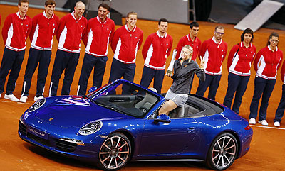 Russia's top seed and holder Maria Sharapova celebrates after she won a Porsche 911 4S in the final of the Stuttgart tennis Grand Prix following her victory against China's Li Na, on Sunday