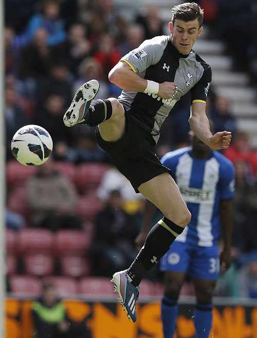 Tottenham Hotspur's Gareth Bale charges down a clearance from Wigan Athletic's goalkeeper Joel Robles to score during their English Premier League match on Saturday