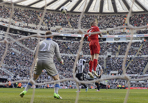 Liverpool's Daniel Agger (right) heads to score against Newcastle United during their English Premier League match on Saturday