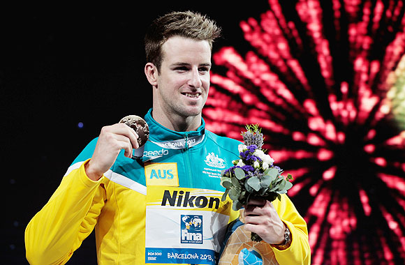 Gold medal winner James Magnussen of Australia celebrates on the podium on Thursday