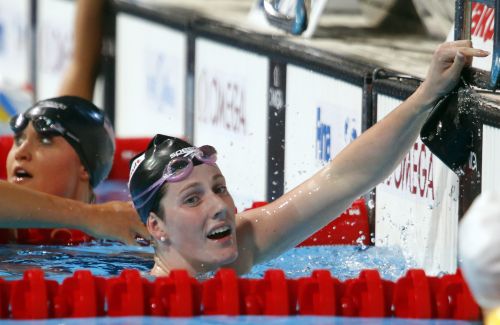 Missy Franklin of the U.S. (R) reacts next to compatriot Elizabeth Pelton after winning the women's 200m backstroke final
