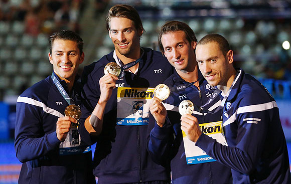 Gold medal winners Giacomo Perez-Dortona, Camille Lacourt, Fabien Gilot and Jeremy Stravius of France celebrate on the podium after the Swimming Men's Medley 4x100m Relay final in Barcelona on Sunday